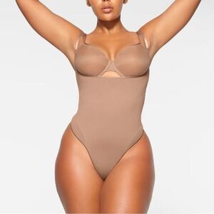 SKIMS Seamless Sculpt Open Bust Thong Bodysuit in Sienna
